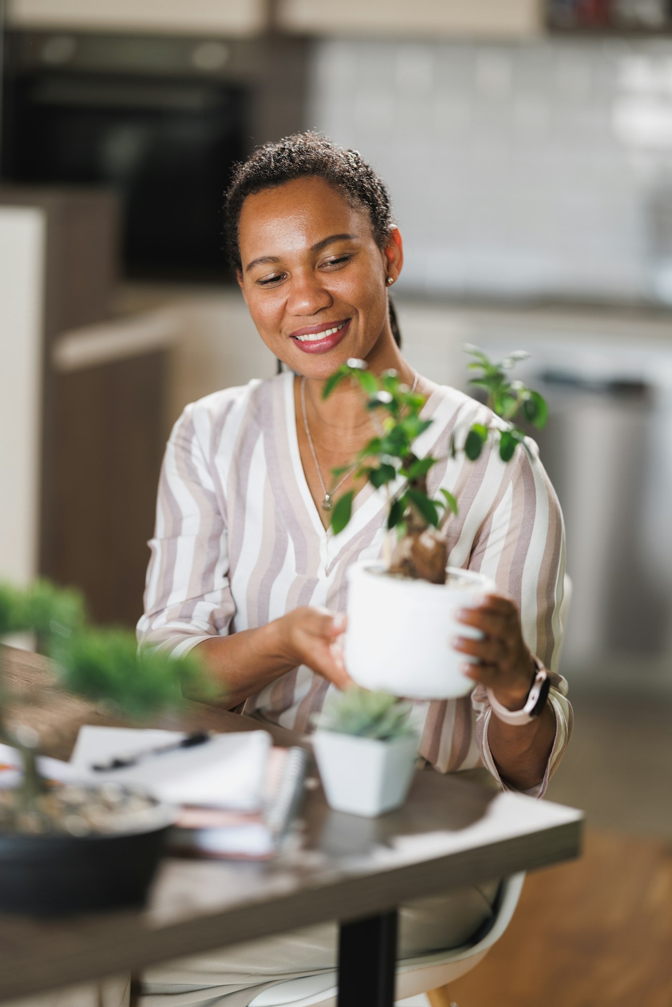 Black Woman Taking Care Of Houseplants