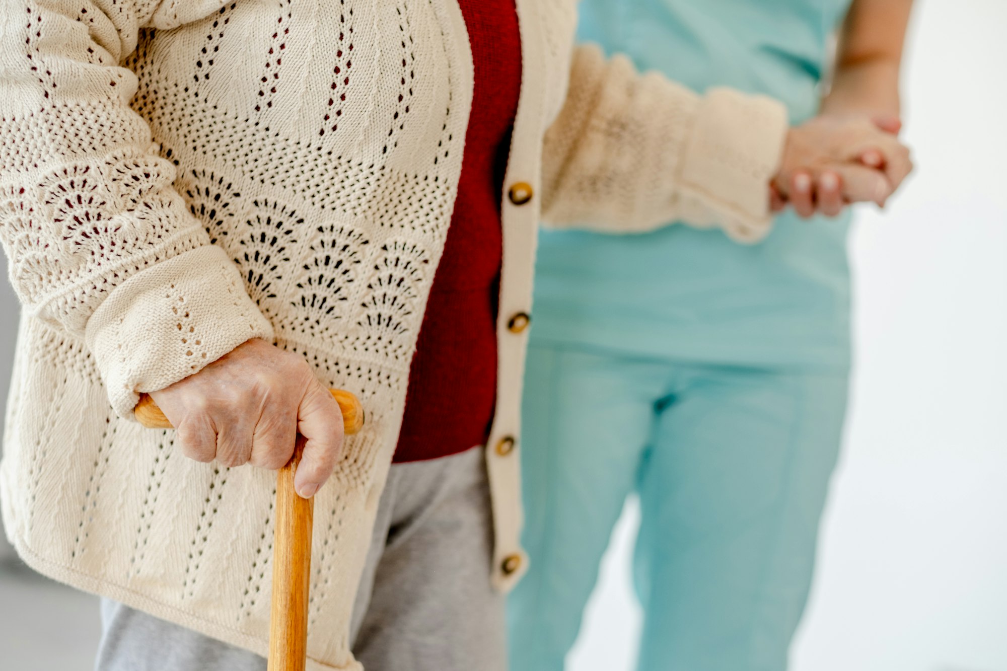 Nurse Assists Elderly Woman To Walk In Nursing Home